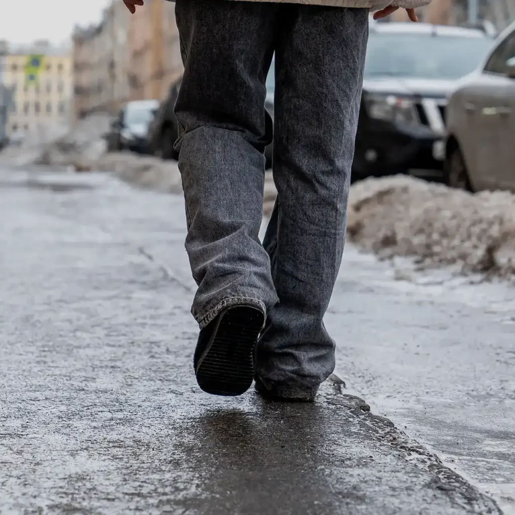 shoes walking down a sidewalk in the winter